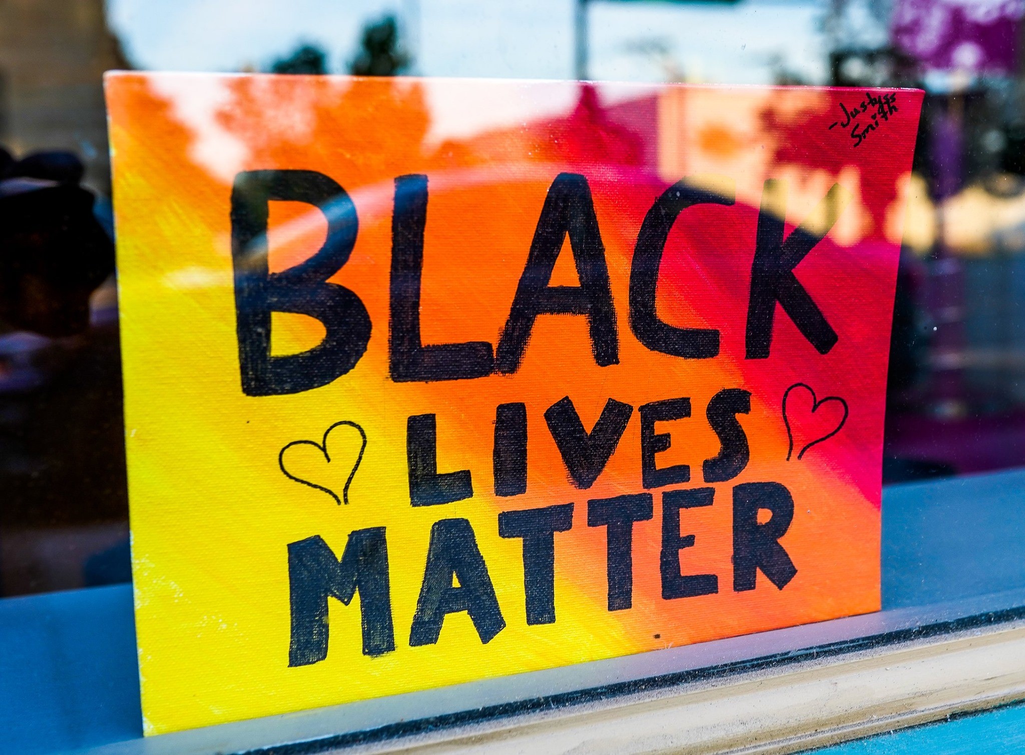 Black Lives Matter poster in window of downtown business.