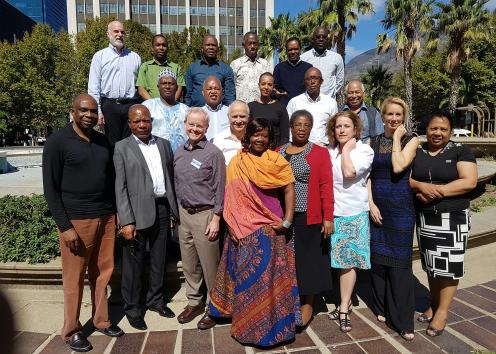 Photo of Stephen Fawcett with a group of over 20 people, gathered in Cape Town.